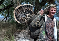 Youth holding turkey. Learn about responsible hunting through Hunter Education from New Mexico Game & Fish